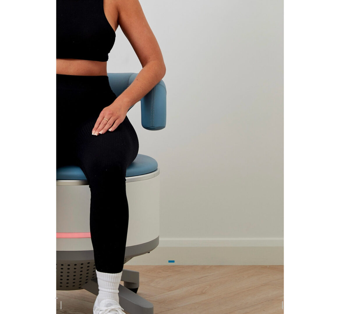 Person in black workout clothes seated on chair