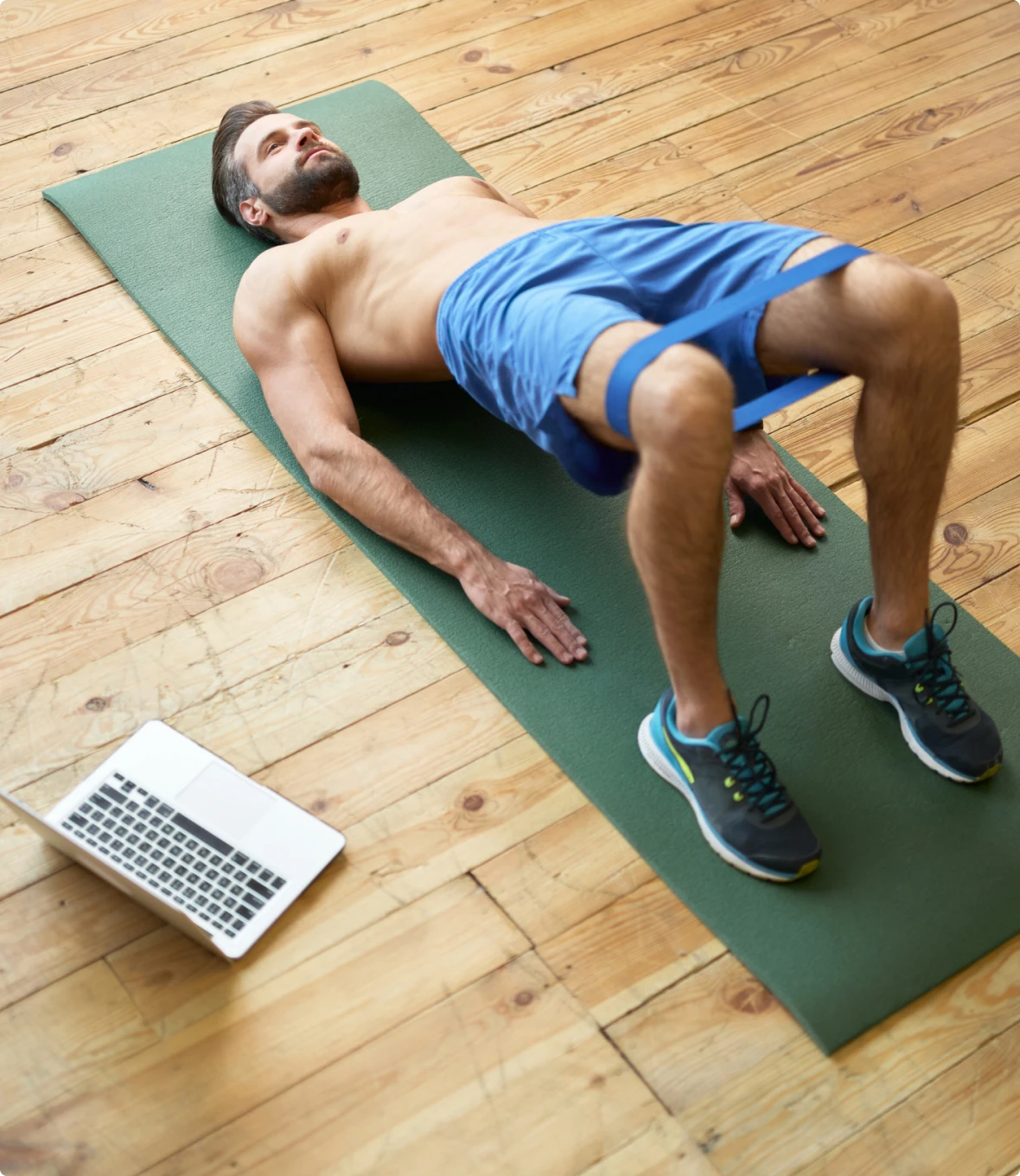 Man exercising on yoga mat at home