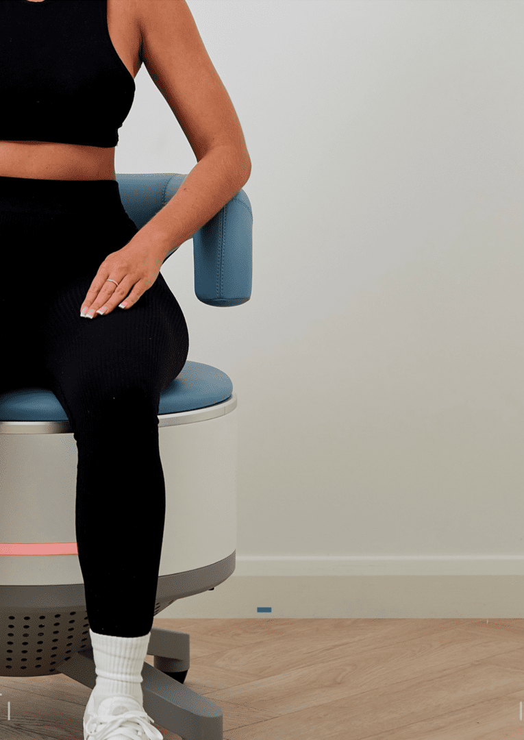 Woman in black workout clothes sitting on chair
