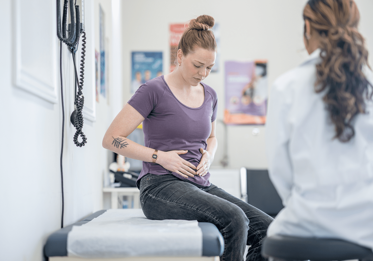 Woman with stomach pain at clinic
