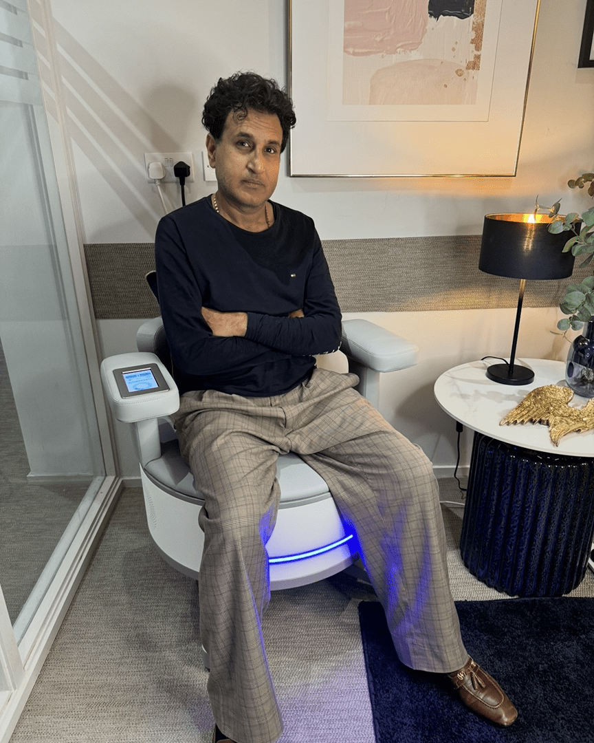 Person sitting on futuristic illuminated bathroom chair