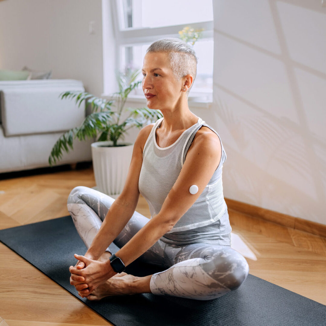 Senior woman meditating on yoga mat